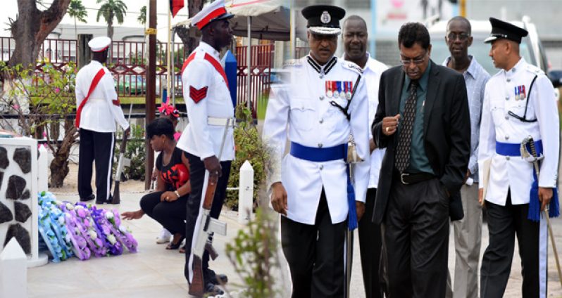 Commissioner of Police Seelall Persaud and Public Security Minister Khemraj Ramjattan in discussion shortly after the minister arrived for the ceremony. At right, a relative lays a wreath in rememberance of her hero