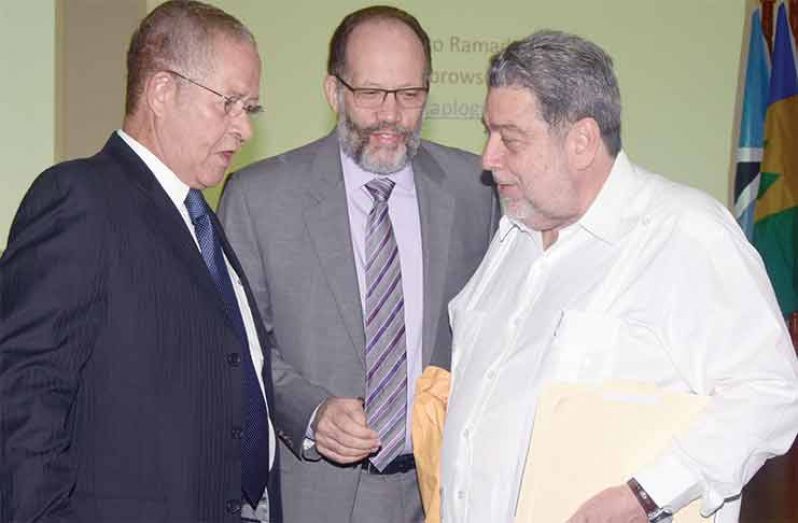 Prime Minister of St Vincent and the Grenadines Dr Ralph Gonsalves (right) interacts with former Prime Minister of Jamaica, Bruce Golding (left) and Caricom Secretary-General Irwin LaRocque (center) Friday ahead of the opening of the two day stakeholders’ forum on CSME. (Adrian Narine)