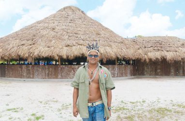 Village Council Treasurer, Paul Andrews, poses in front of the Pakuri benab.