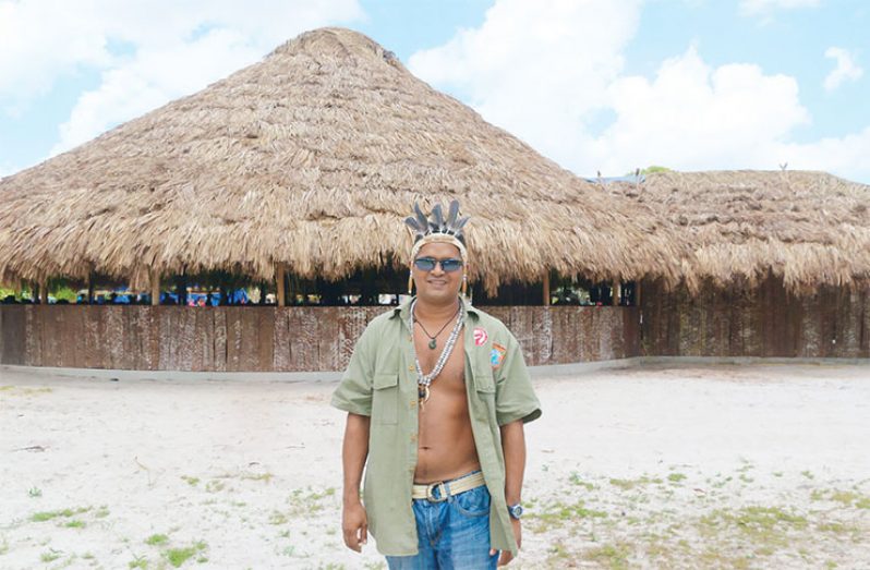 Village Council Treasurer, Paul Andrews, poses in front of the Pakuri benab.