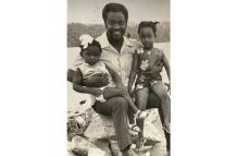 Flashback photograph of Farrier and his two
daughters, Arlene and Venita, seated on boulders
on the bank of the Mazaruni River while
on one of their many hinterland tours