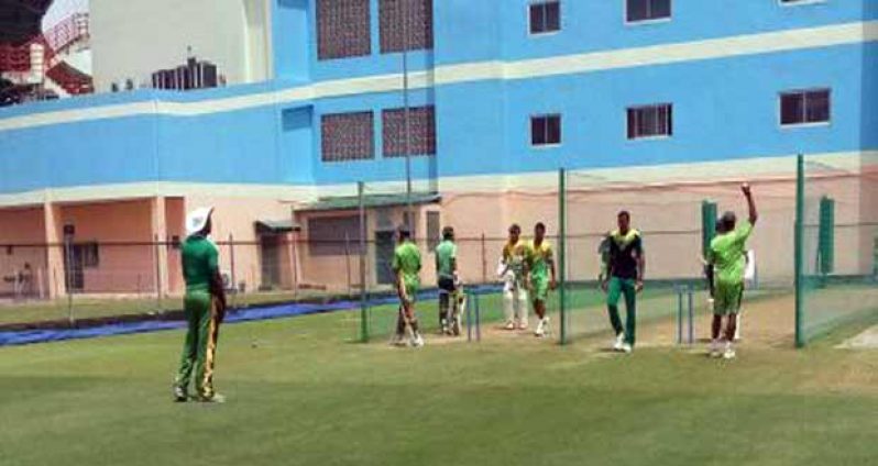 The Guyanese under the watchful eyes of coach Esaun Crandon go through their net sessions in sweltering heat at the venue yesterday