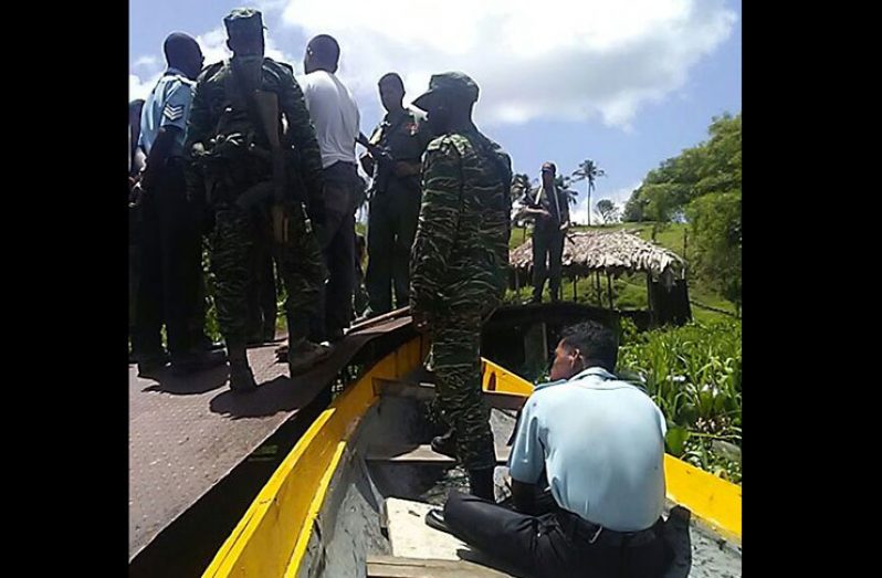 Guyanese soldiers confront their Venezuelan counterparts at the Amacuro River border last Friday