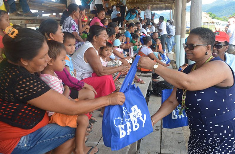 Minister of Public Health, Volda Lawrence distributes baby hampers to the mothers of Lethem, Region Nine.