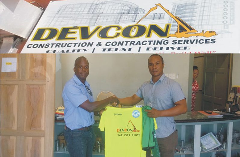 Technical Adviser of Victoria Kings Football Club – Everal Mundy receives the new kit from Managing Director of Devcon Construction, Nolan Lancaster.