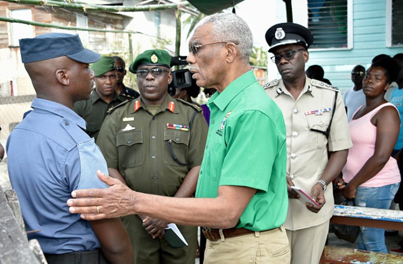 President David Granger sympathises with Mr. Roberto Durant, son of Ms. Denise Josiah. Also photographed are Brigadier Patrick West, Chief of Staff of the Guyana Defence Force and Mr. Nigel Hoppie, Deputy Commissioner, Guyana Police Force (MoTP photo)