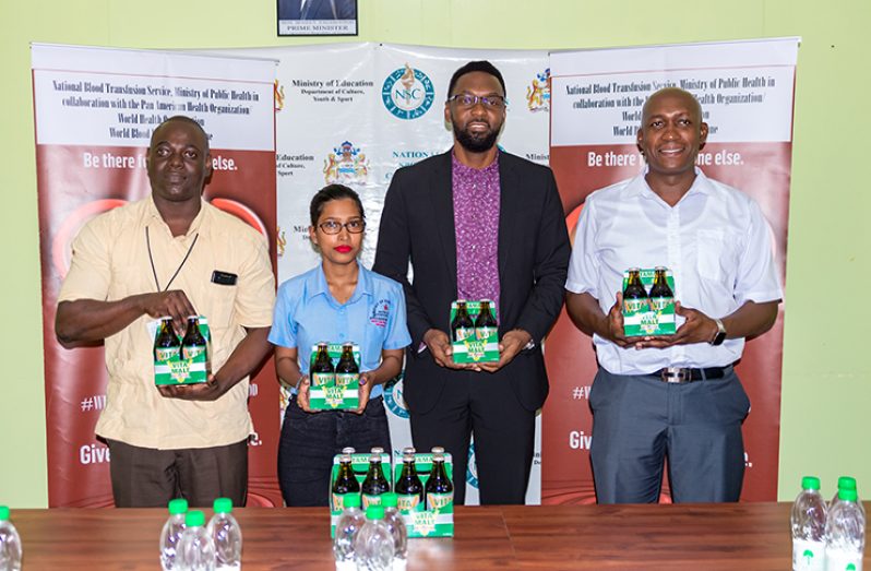 (L-R) Dr. Pedro Lewis, Director of Sport Christopher Jones and Clayton McKenzie, Banks DIH Limited Non-Alcoholic Brand Manager.