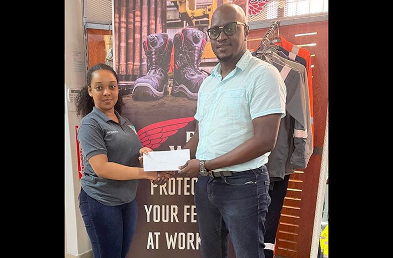 VSH Guyana Inc.’s Kerisha Beete (L) makes a presentation to organizer, Rawle Toney, at their Carmichael Street, Georgetown location