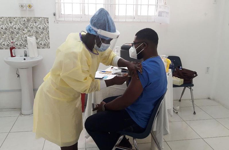 Dr Leron Henry being vaccinated on Wednesday