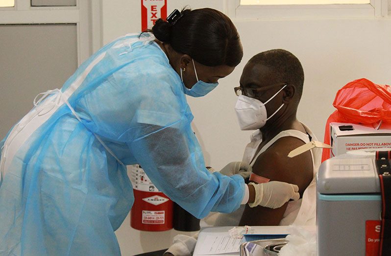A health worker receiving his Oxford-AstraZeneca vaccine at the National Infectious Diseases Hospital