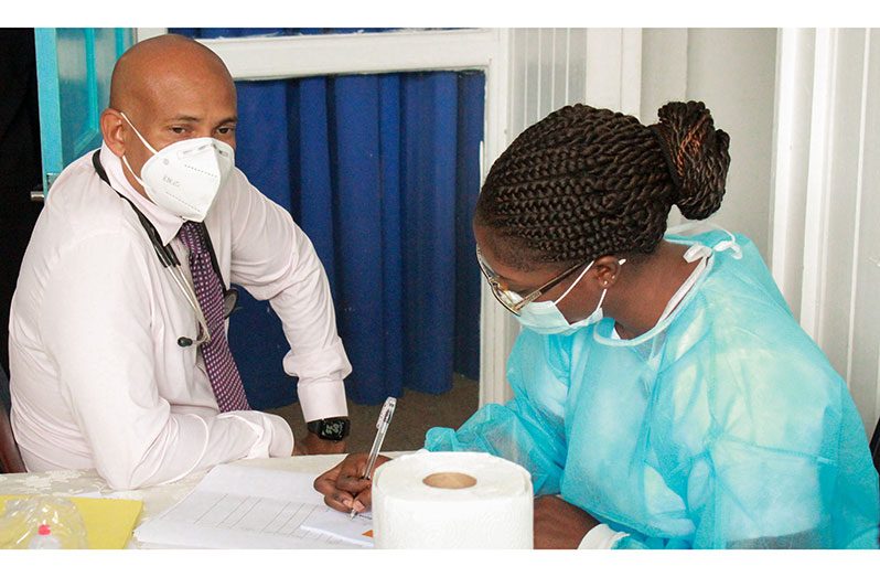 A nurse collecting basic information from head of Medical Services at the GPHC, Dr Mahendra Carpen before he gets the COVID-19 vaccine (Vishani Ragobeer photo)