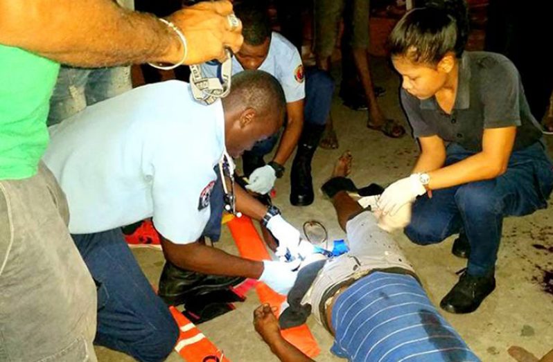 Medical personnel attending to the injured man.