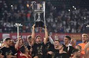 Valencia players celebrate with their trophy after winning the 2019 Spanish Copa del Rey (King's Cup) final football match against Barcelona at the Benito Villamarin stadium in Sevilla on Saturday. (AFP)
