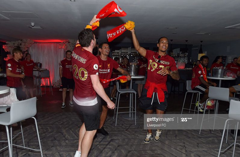 Virgil van Dijk, Andy Robertson and Dejan Lovren of Liverpool celebrating winning the Premier League on June 25, 2020 in Liverpool, England. (Photo by Liverpool FC/Liverpool FC via Getty Images)