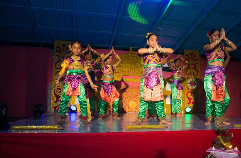 Dancers from the Dharmic Swarswattie Dance Academy performing on stage for the cultural evening.