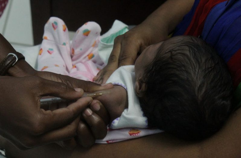 A baby being vaccinated at the High Dam Health Centre as Vaccination Week in the Americas 2019 was launched