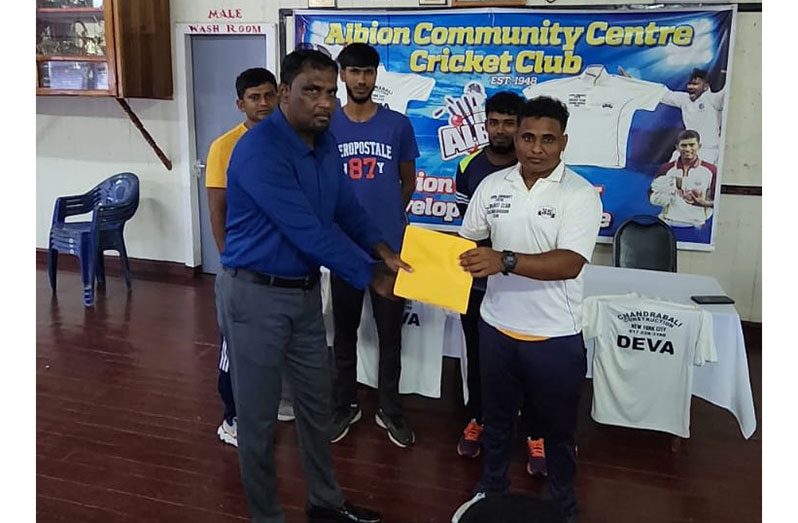 ACCCC president, Vemen Walter (left), receives the sponsorship cheque from a representative of Chandrabali's Construction