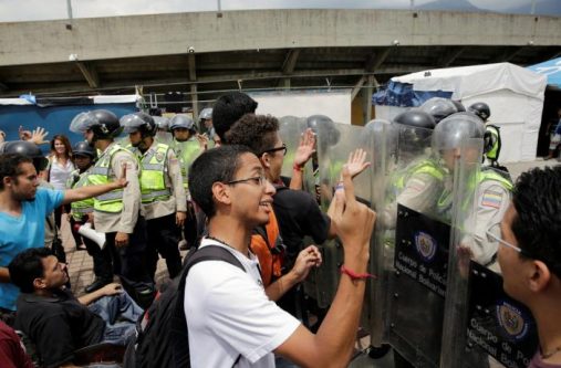 Demonstrators shout slogans in front of riot police during a student rally demanding a referendum to remove Venezuela's President Nicolas Maduro in Caracas, Venezuela October 24, 2016. REUTERS/Marco Bello