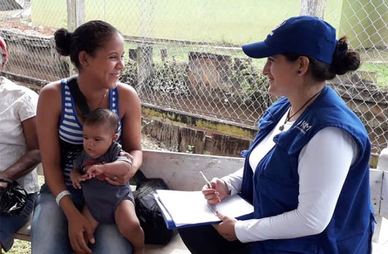 A mother being interviewed by an official of the International Organisation for Migration at Kumaka, Mabaruma sub-region. (IOM photo)