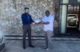 Executive Director of P&P Insurance Brokers, Vikash Panday (left), hands over the sponsorship cheque to GSCL President, Ian John