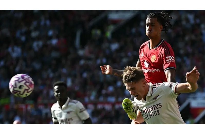 Arsenal striker, Viktor Gyokeres and Manchester United defender, Leny Yoro, tussle for possession at Old Trafford