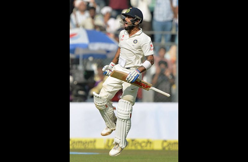 Virat Kohli roars on reaching his 15th Test hundred against England in Mumbai on the third day.