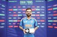 Virat Kohli poses with the Player of the Match award.