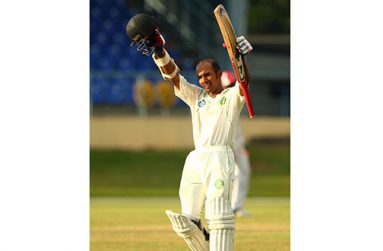 Vishal Singh celebrates his maiden first-class ton at the Queen’s Park Oval, yesterday.