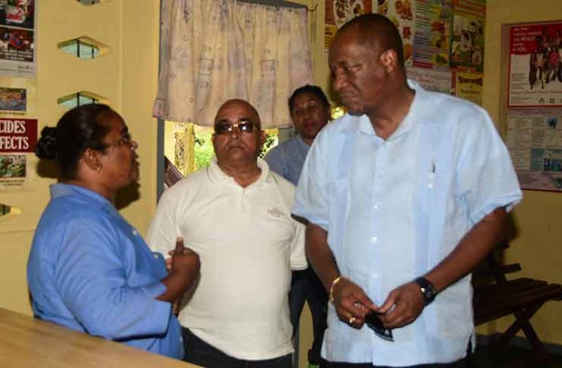 Minister Harmon; REO Denis Jaikaran, and Bonasika Health Centre staff Dooknie Ramsamoog in discussion (Adrian Narine Photo)