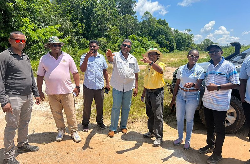 GWI CEO, Shaik Baksh (third right) and Bartica Major, Anthony Murray (fourth left) share their views on a potential location for a small treatment plant that will serve residents of Five Mile and the new Housing Scheme at Seven Mile, Bartica, as technical officers listen attentively