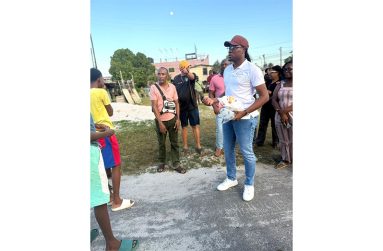 Minister Jacobs (front), Assistant Director of Sport Franklin Wilson (partly hidden by the minister), meet with the residents of West Ruimveldt on Saturday.
