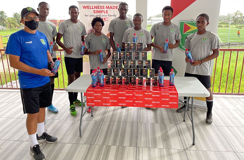 Members of the National team display GNC Mega Men Sport multivitamins and Lucozade sports drink.