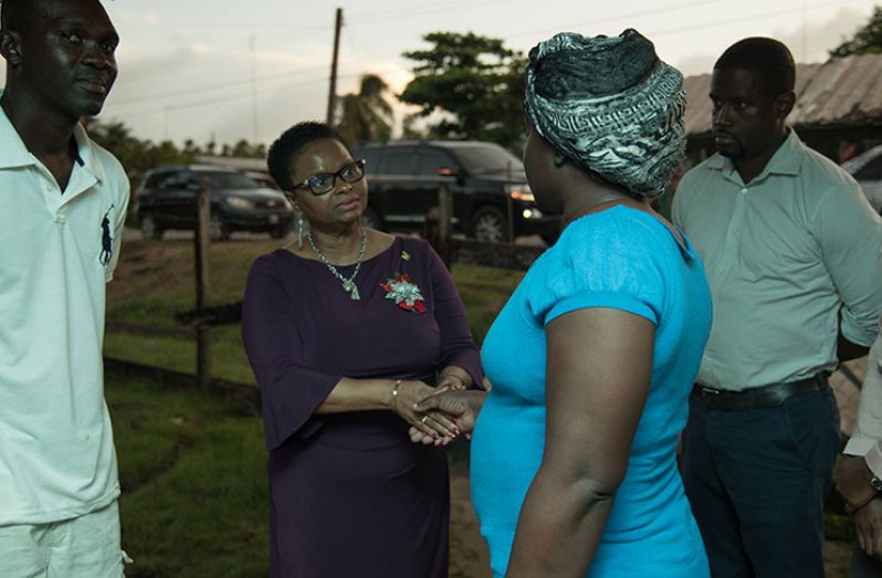 Minister of Public Health, Volda Lawrence, extending condolences to the Sealey family in the company of Regional Health Officer, Dr. Desmond Nickholson 0