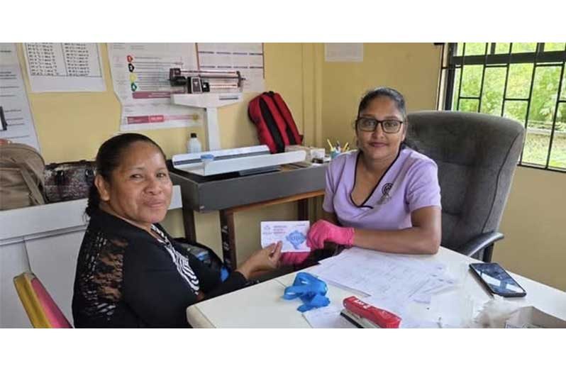 A resident collects her health voucher 