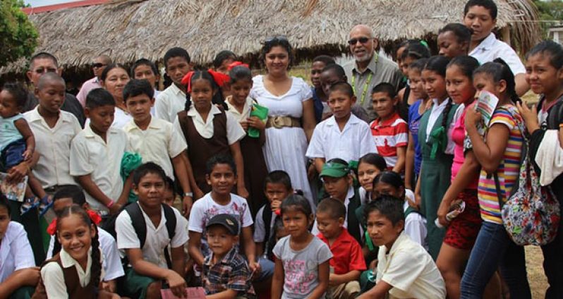 President Donald Ramotar and Education Minister, Priya Manickchand with students during the distribution of ‘Because We care’ education grants in the heinterland communities