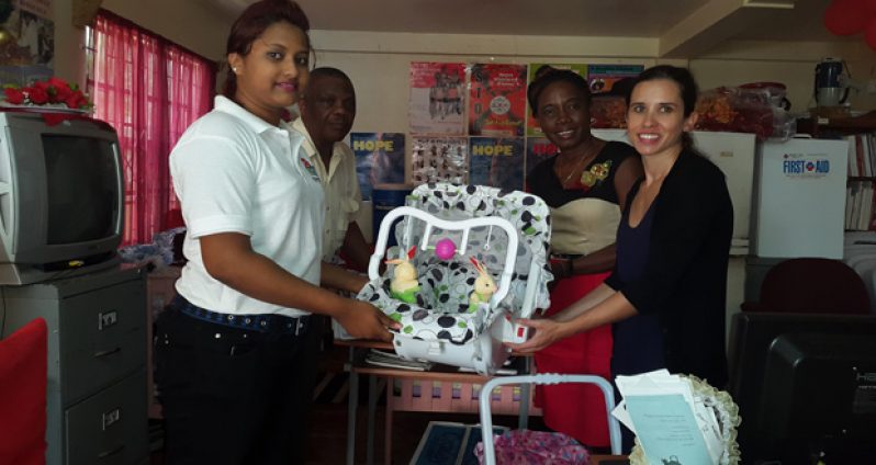 Lawrence Mentis and a staff member from Julius Variety Store during the presentation yesterday to WAD representatives Clonel Samuels-Boston and Danielle Blondin at WAD’s office (Photo by Michel Outridge)