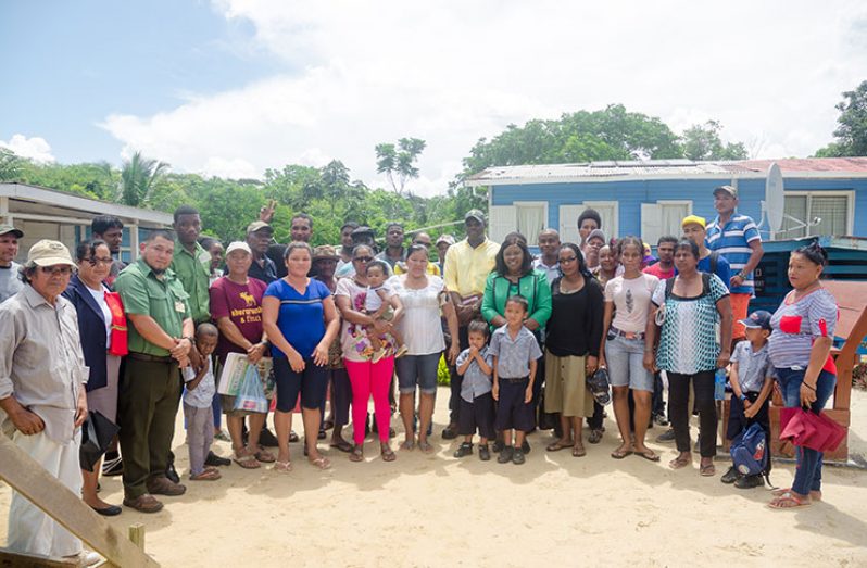 Winiperu residents take a photograph with the ministers following the meeting (Delano Williams photo)