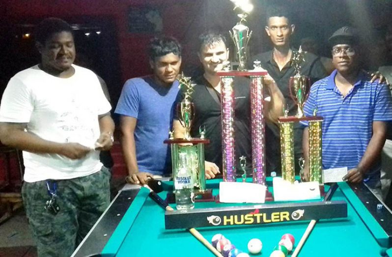 Anthony Xavier (3rd from left) shows off his championship trophy in the company of other prize-winners and organiser Ricardo Devers (2nd from right).