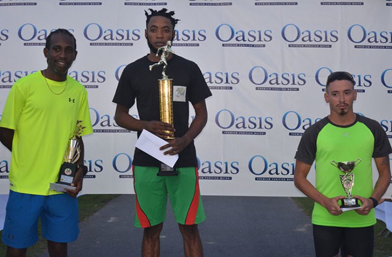 Winston Missigher, flanked by Cleveland Thomas (first from left) and Jonathan Fagundes on the medal podium after winning the AAG/Oasis Water 5km Run/Walk (Rawle Toney photo)