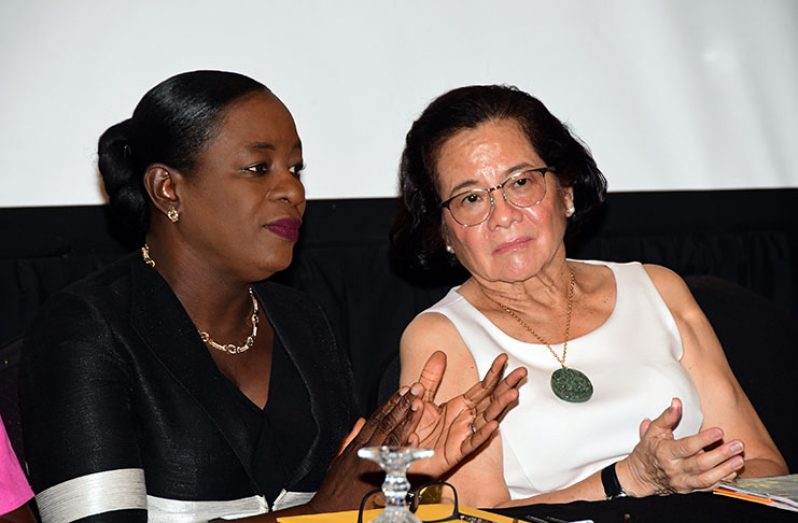 First Lady, Sandra Granger (right) and Minister of Education, Dr. Nicolette Henry interact during the Gender and Development Workshop on Wednesday (Adrian Narine photo)