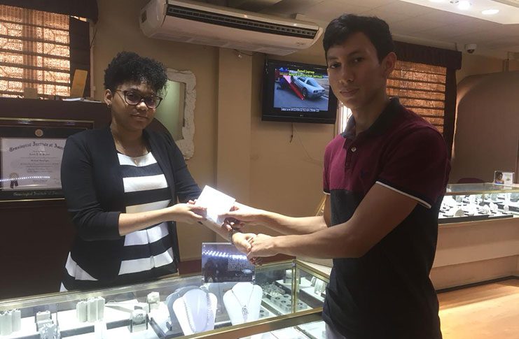 Miguel Wong receives King’s Jewellery World’s contribution from a representative of the business entity.