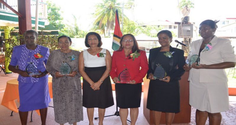 First Lady Deolatchmee Ramotar with women who were honoured for their contributions to Guyana
