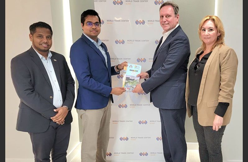 Business development consultant and owner of ACE Consultancy, Dr. Rosh Khan (second from left) and Director of Vitality Accounting, Abbas Hamid, hand over a token to President and CEO of the World Trade Center Miami, Ivan Barrios, in the presence of Senior Vice President & COO of the World Trade Center Miami, Alice Ancona