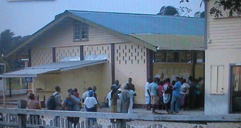 Voters waiting to exercise the franchise at a school on the Essequibo  Coast