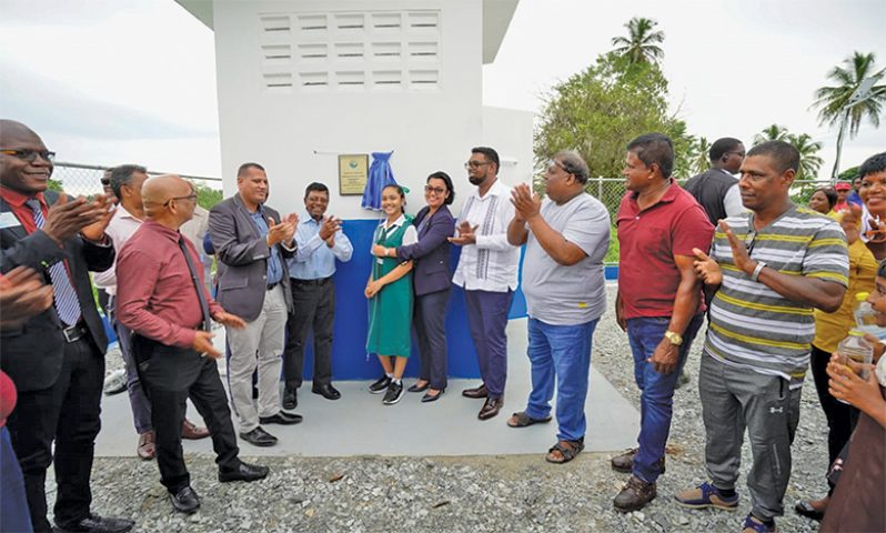 President, Dr. Irfaan Ali (fourth from right) with Housing and Water Minister Collin Croal (third from left), Minister within the Minister of Housing and Water Susan Rodrigues (fifth from right), GWI’s CEO, Shaik Baksh (fourth from left) at the commissioning of the new well on Wakenaam Island (Office of the President photo)