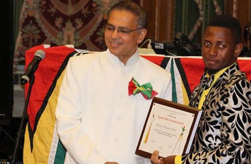 Mwanza receiving his award from the Guyana Cultural Association of New York