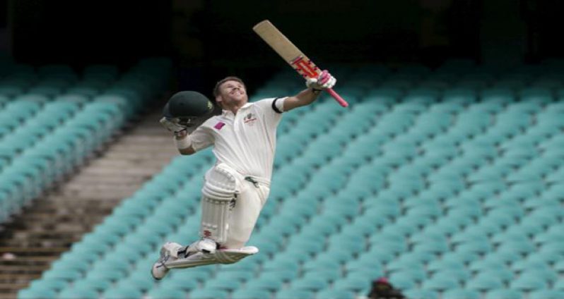 Australian batsman David Warner celebrates scoring a century against the West Indies on the final day of their third cricket Test in Sydney January 7, 2016.