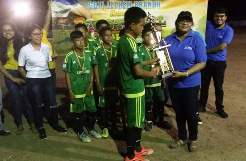 Paimowak Warriors receives the championship trophy from GBTI’s Lethem Branch Manager Ms Sharon King.