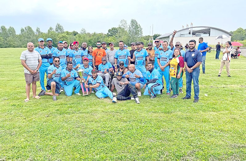 The victorious Leguan Warriors players and supporters with OSCL executive members. President Shiv Persaud is extreme right