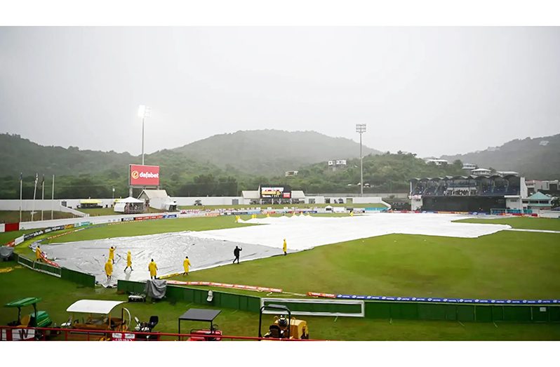 Ground staff bring on the covers as rain stops play  •  Getty Images